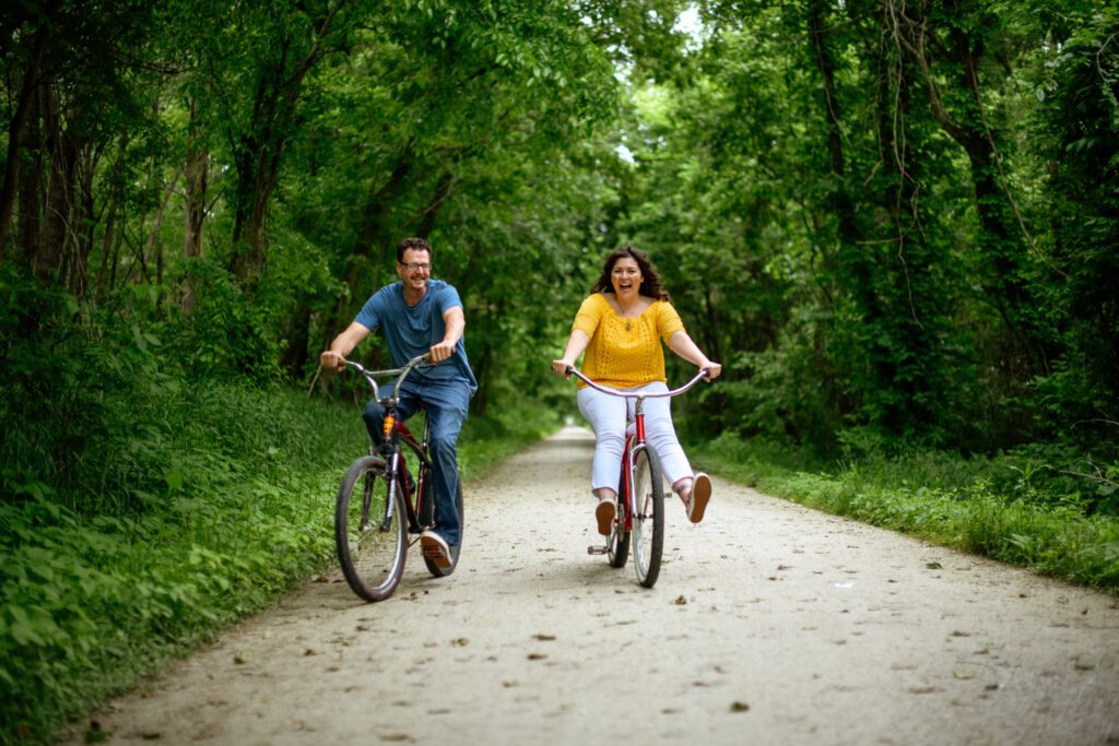 Couple riding bikes on the gravel Katy Trail.