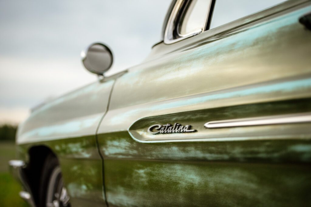 Quarter panel side shot of green Pontiac Catalina name plate 
