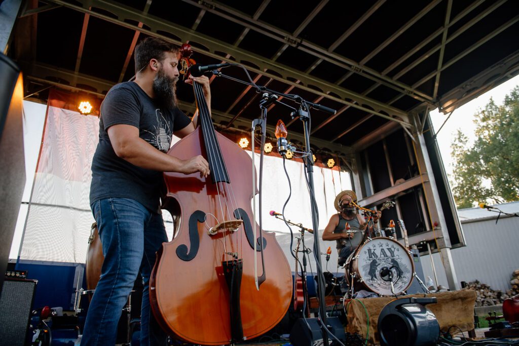 Bearded man plucks upright bass