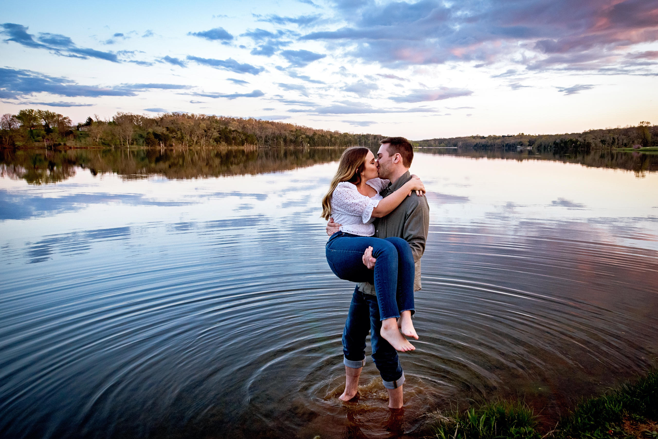 Couple kiss in lake at sunset