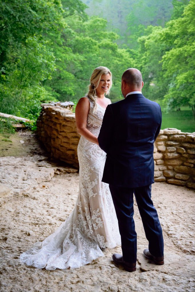 bride and groom first look at great spirit falls in dogwood canyon