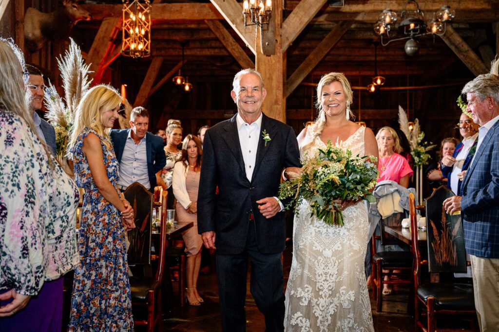 Father walks bride down the isle inside Dogwood Canyon Lodge