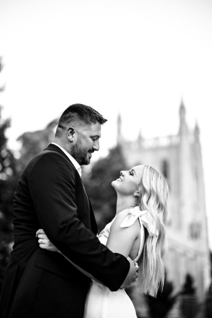 Couple smiling at each other in front of Memorial union in Black and White.