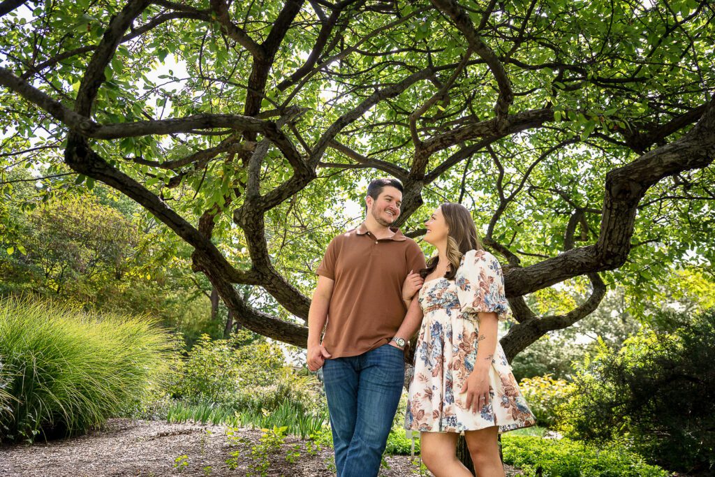 couple stand in front of neat tree